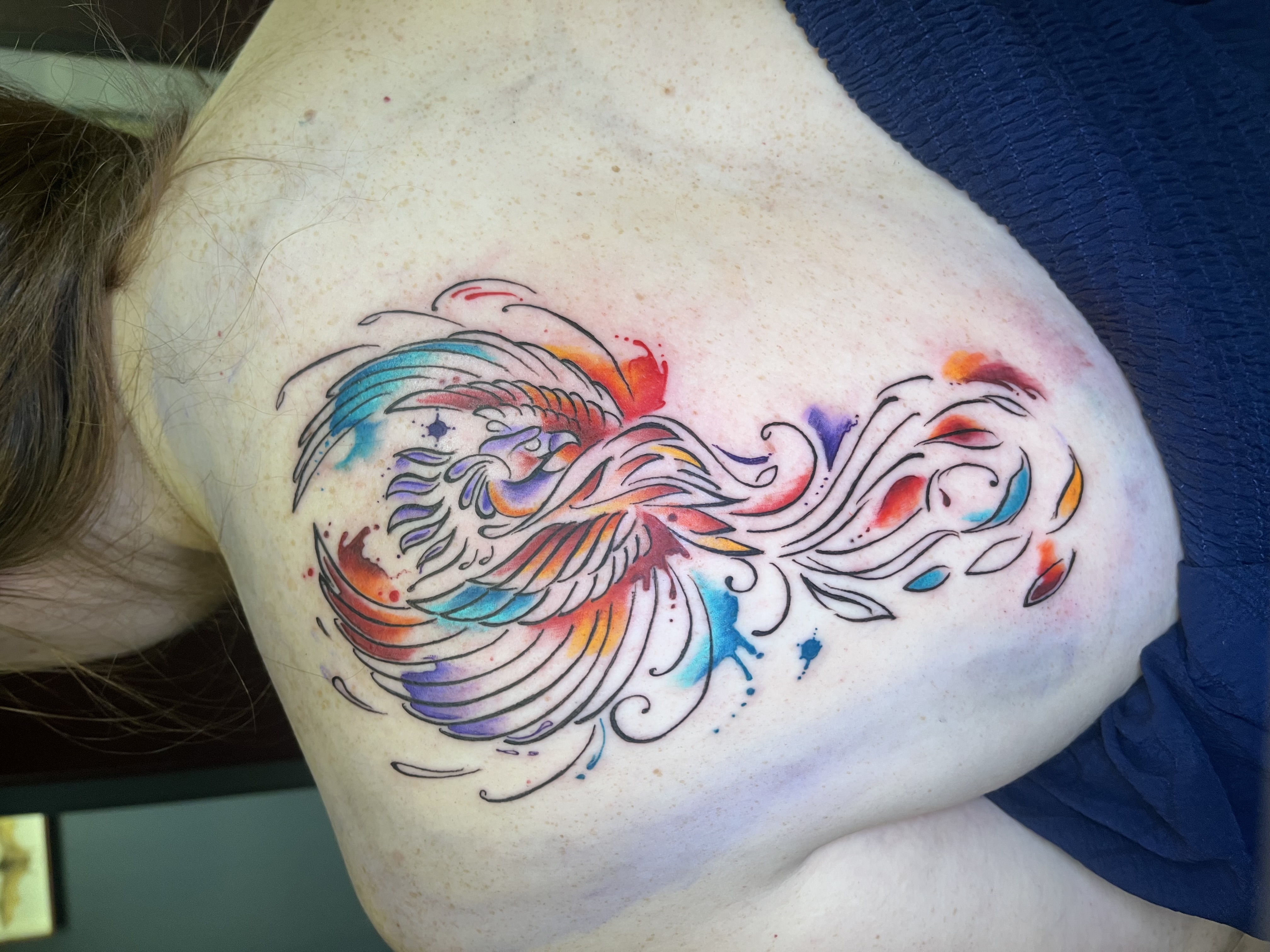 Watercolour phoenix tattoo with vibrant colour splashes by Leo