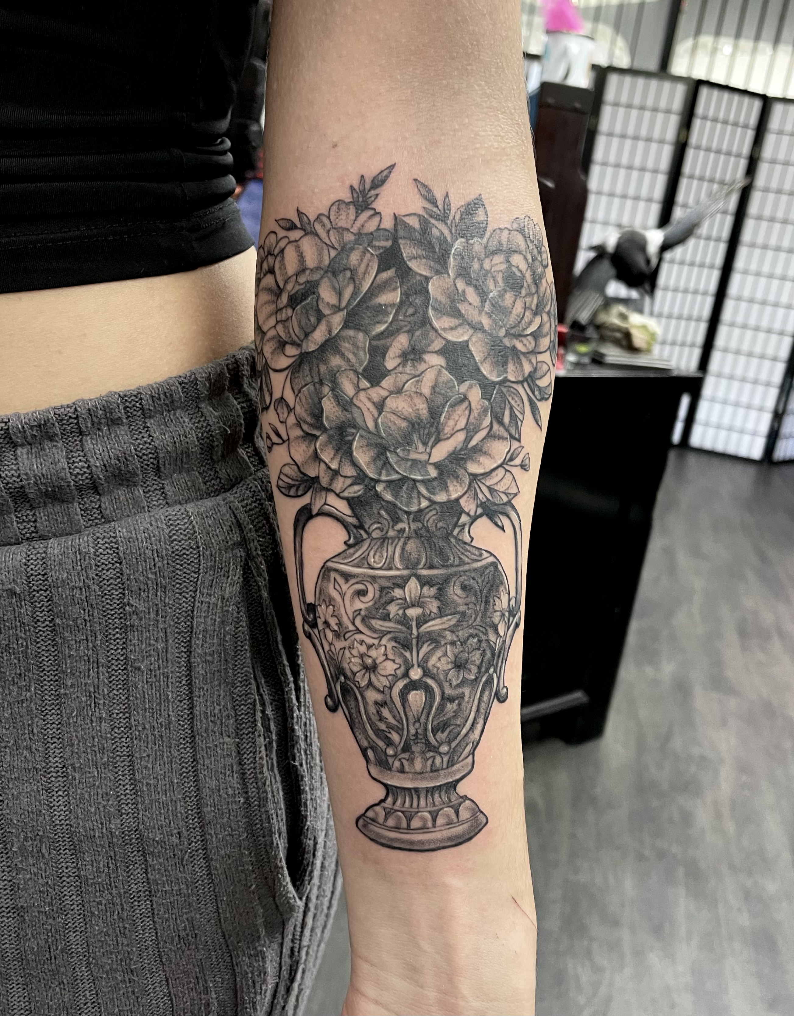 Black and grey ornate vase with peonies and roses forearm piece by Matt